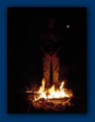 Larry standing in campfire